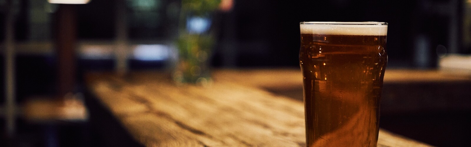 a glass of beer on top of a table