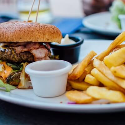 a dish with hamburger and french fries with sauce