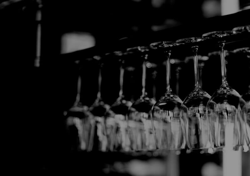a zoomed-in photo of wine glasses hanging upside down